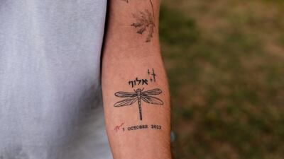 Kibbutz member Avi Ben Zaken shows his tattoo to commemorate the people from his community that were killed and taken hostage during the October 7, 2023 attack on southern Israel by Hamas. Reuters