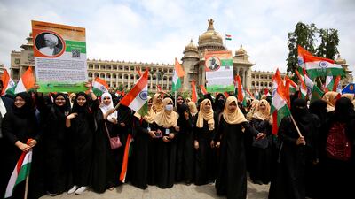 Muslim women carry Indian flags the celebrate Independence Day, in front of Vidhana Soudha, the seat of the state legislature of the south-western state of Karnataka, in Bangalore. EPA