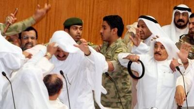 Kuwaiti Shiite and Sunni MPs fight during a heated parliament debate over inmates in the US Guantanamo detention centre in Kuwait City yesterday.