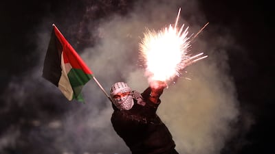 A pro-Palestinian demonstrator hurls fireworks at the Israeli Embassy in Athens during a rally in solidarity with the Palestinian people and against the ongoing Israeli intervention in the Gaza Strip, in Athens, Greece. EPA