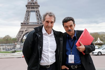 French journalists Jean-Jacques Bourdin, left, and Edwy Plenel pose in front of the Eiffel Tower ahead of a combative interview with French president Emmanuel Macron in Paris. EPA