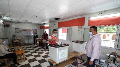 A man casts his ballot at a polling station on August 11, 2020 during the election for Egypt's new senate. AFP