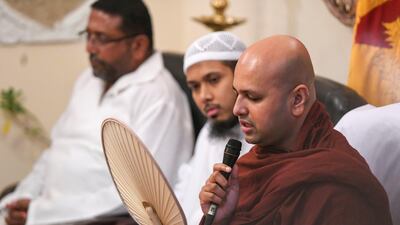 Buddhist monk Rammuthugala Buddhawansa Thero prays for the people who lost their lives.