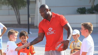 England international Ugo Monye interacts with children during his visit to the Etihad Airways Abu Dhabi Harlequins Junior Rugby tournament at Zayed Sports City in Abu Dhabi on Saturday. Ravindranath K / The National