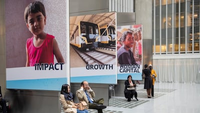 People listen to a panel discussion during the IMF World Bank Annual Meetings at the World Bank Headquarters in Washington on Wednesday. EPA