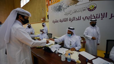 A Qatari man receives his ballot paper in Doha. Reuters