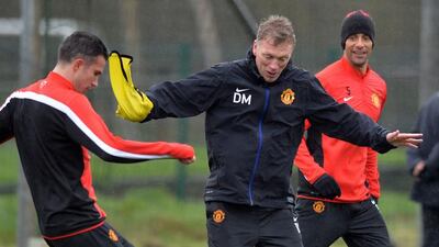 David Moyes with Robin van Persie, left, and Rio Ferdinand, right, on Tuesday. Paul Ellis / AFP / March 18, 2014