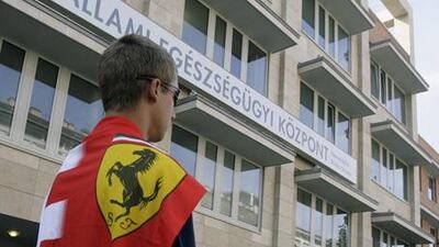 A Ferrari fan waits in front of the hospital of Ferrari driver Felipe Massa in Budapest yesterday. Doctors have said his condition is no longer life threatening.