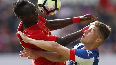 Liverpool forward Sadio Mane in action with Wigan’s Ryan Colclough. Lee Smith / Reuters