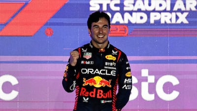 Sergio Perez celebrates on the podium. Reuters
