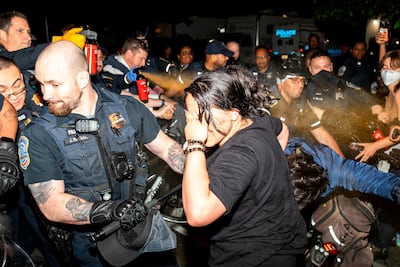 Metropolitan Police use pepper spray on demonstrators at George Washington University on Wednesday. AP