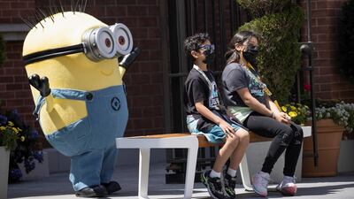 Guests pose with a Minion character on the reopening day of Universal Studios Hollywood during the outbreak of the coronavirus disease, in Universal City, California, US. Reuters