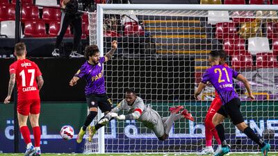 Shabab Al Ahli goalkeeper Majed Naser saves the ball.