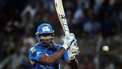 NAVI MUMBAI, INDIA - APRIL 21: Kieron Pollard of the Indians hits out as Kevin Pietersen of the Challengers looks on during the 2010 DLF Indian Premier League T20 semi final match between Mumbai Indians and Royal Challengers Bangalore played at DY Patil Stadium on April 21, 2010 in Navi Mumbai, India. (Photo by Daniel Berehulak-IPL 2010/Indian Premier League)