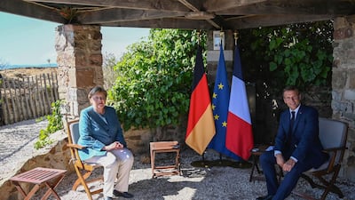 German Chancellor Angela Merkel, left, and French President Emmanuel Macron meet at the Fort de Bregancon, southern France, Thursday, Aug. 20, 2020 AP