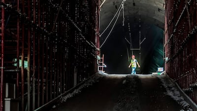 A construction worker walks through the entrance of the new twin-tube tunnel. AFP