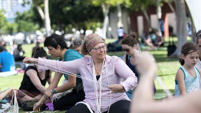 A woman attends the class under a tent.