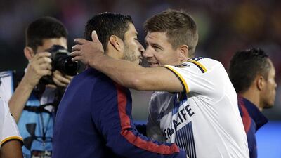 LA Galaxy's Steven Gerrard, right, of England, hugs former Liverpool teammate Luis Suarez of Barcelona on Tuesday before their pre-season friendly in California. Jae C Hong / AP