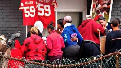 Friends and relatives of Kansas City Chiefs linebacker Jovan Belcher grieve outside the player's home. Belcher shot and killed his girlfriend before taking his own life.