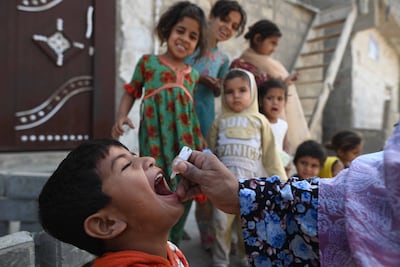 A child receives an anti-polio vaccine in Karachi, Pakistan on December 15. Few humanitarian investments offer such enduring returns at such low cost. EPA