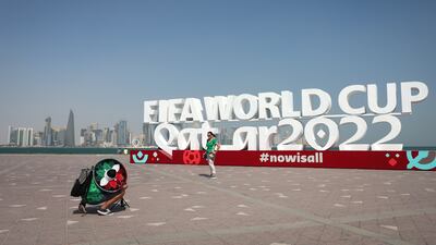 DOHA, QATAR - NOVEMBER 20: Supporters take photographs in-front of Qatar World Cup signage ahead of the FIFA World Cup Qatar 2022 at on November 20, 2022 in Doha, Qatar. (Photo by Alex Pantling / Getty Images)