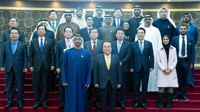Sheikh Mohamed bin Zayed stands for a photograph with Moon Hee-sang.