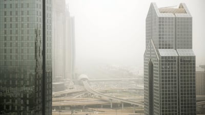 Sheikh Zayed Road is foggy in parts this morning with some dust forecast this afternoon. Reem Mohammed / The National.