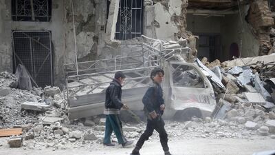Children inspect damages on a street in the besieged town of Douma, eastern Ghouta. The UN made an urgent plea last Tuesday for warring sides in Syria to temporarily lay down their arms and allow aid deliveries to desperate civilians. Bassam Khabieh / Reuters