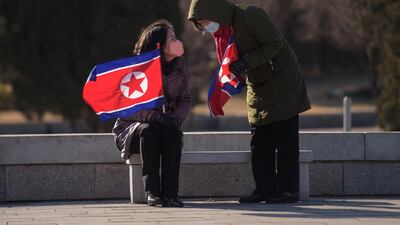 Two women sit in a park in front of the Grand People's Study House in Pyongyang. AFP