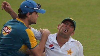 A physio gives treatment to Pakistani cricketer Yasir Shah during the second day of the third and final Test between Pakistan and the West Indies at the Sharjah Cricket Stadium on October 31, 2016. Aamir Qureshi / AFP
