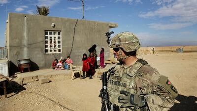 US Army soldiers speak to families in rural Anbar on a reconnaissance patrol near a coalition outpost in western Iraq. AP