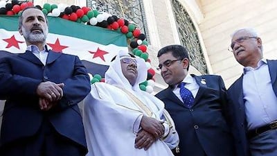Moaz Al Khatib (left), Syrian interim government prime minister Ghassan Hitto (second from right) and the SNC's George Sabra (right) stand with a Qatari official at the inauguration of the Syrian interim government’s embassy in Doha.