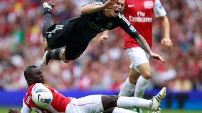 Arsenal's Emmanuel Frimpong sends Liverpool's Daniel Agger flying at Emirates Stadium, one of many of his reckless plays.