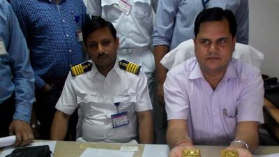 A customs officer shows 24 gold bars to media after being seized at the Netaji Subhash Chandra Bose International Airport in Calcutta. EPA