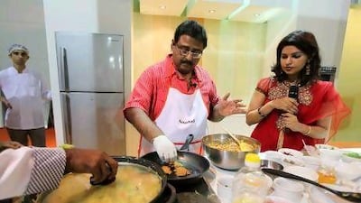 Naushad, or the Big Chef, from Kerala, makes kuttanadan chicken roast at the Sharjah International Book Fair. Pawan Singh / The National