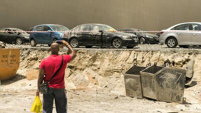 Cars parked under Torch tower bore the brunt of the falling debris. Reem Mohammed / The National.
