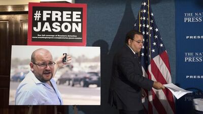 Ali Rezaian, brother of Jason Rezaian (in framed pictured) who is the Washington Post’s Tehran bureau chief, at a news conference in Washington on July 22, 2015. The Washington Post has filed an urgent petition asking help from a United Nations agency to secure the release of Rezaian who is currently being held in Evin Prison in Iran. Molly Riley/ AP Photo