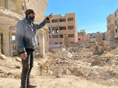 A former rebel fighter stands in front of the remains of the ancient Jobar synagogue. Khaled Yacoub Oweis / The National