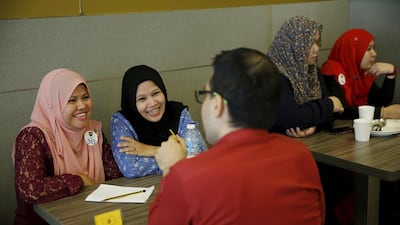 Majudi, left, with her chaperone Norwati, second from left, smile at Halal Speed Dating, a matchmaking event, in Kuala Lumpur, Malaysia October 3, 2015. Olivia Harris / Reuters