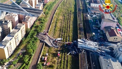 Rescue teams work among the rubble of the collapsed Morando highway bridge in Genoa. Vigili Del Fuoco via AP