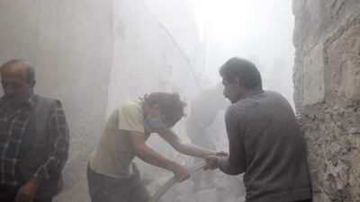Men try to put out fire at a site hit by what activists said was an air strike by forces loyal to Syria's President Bashar Al Assad in the town of Azaz, north of Aleppo, near the border with Turkey, on May 5, 2014. Mahmoud Hassano / Reuters