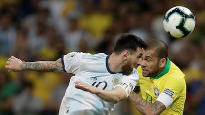 Brazil's Dani Alves, right, in action against Argentina's Lionel Messi. AFP