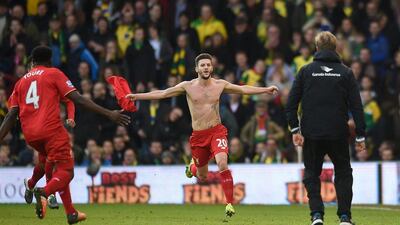 Liverpool’s Adam Lallana begins to celebrate scoring the winner on Saturday against Norwich City. Jon Buckle / PA / AP