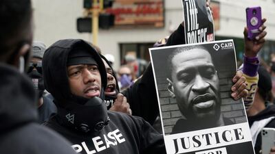 Actor and comedian Nick Cannon celebrates the memory of George Floyd and demands justice outside the Cup Foods store on Chicago Avenue in Minneapolis. Brian Peterson / Star Tribune via AP