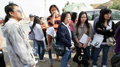 Filipinos standing at the Philippine consulate in Dubai to renew their passports. Jaime Puebla - The National