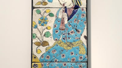 Panel with a flute player, Isfahan or Qazvin, Iran (1680-1730): Perhaps it’s the bowl of pomegranates in the foreground or the exotic yellow and blue plants dancing down the left-hand side but this three-tile ceramic interior decoration has a wonderful feeling of freshness, exuberance and youthful joy. Scenes such as these were widely used in Iran during the 17th century for the decoration of palaces in Isfahan. Pawan Singh / The National