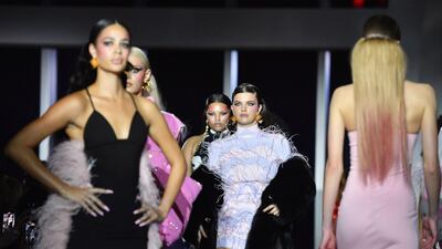 Feathers in pink adorned sleeves and bandeau tops, and trains trailed behind some of his models as they camped it up for the cameras at Christian Cowan. AFP