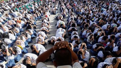 A Filipino highschool teacher oversees students participating in a nationwide earthquake drill in Quezon City, east of Manila, Philippines. EPA