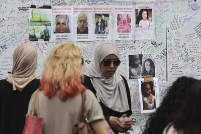 People view messages and missing persons posters at a community centre near Grenfell Tower after the June 2017 fire. AP