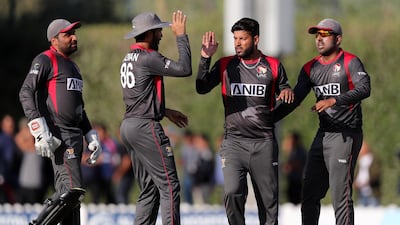 UAE captain Mohammad Naveed, second right, celebrates after taking the wicket of Nepal's Sompal Kami in their T20 clash in January. Chris Whiteoak/The National